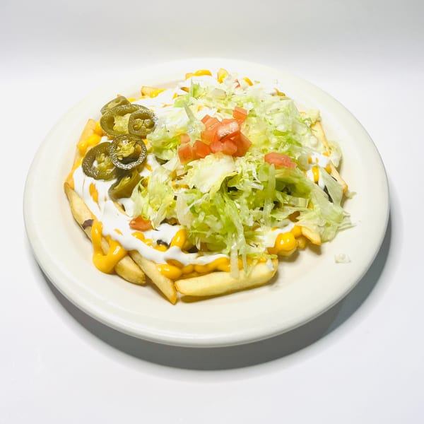 Mister Taco's loaded fries with cheese, sour cream, jalapeños, lettuce, and diced tomatoes.